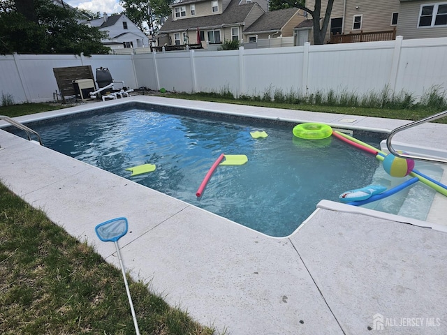 view of pool with fence, a fenced in pool, and a residential view