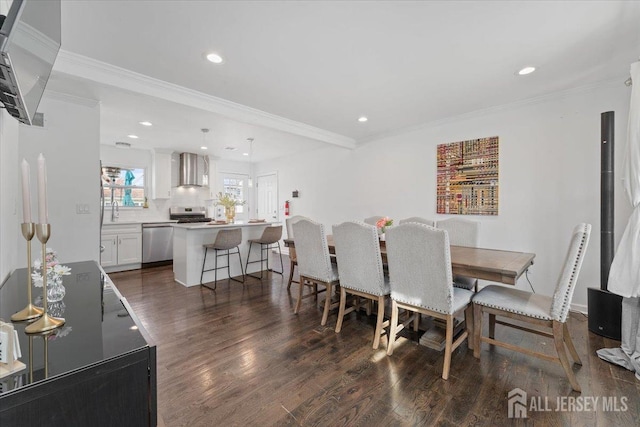 dining room featuring recessed lighting, ornamental molding, and dark wood-style flooring