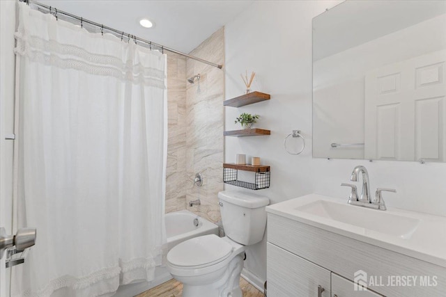 bathroom with vanity, shower / bathtub combination with curtain, and toilet
