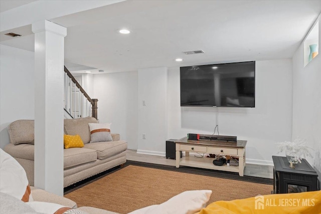 living room with visible vents, stairs, wood finished floors, baseboards, and recessed lighting