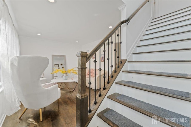 stairway with recessed lighting and wood finished floors