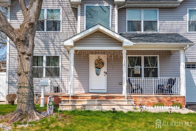 view of front of house with a porch, a shingled roof, and a garage