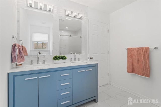 full bathroom featuring a sink, a shower stall, double vanity, and marble finish floor