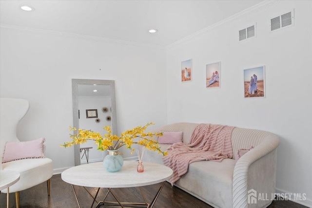 living area with crown molding, recessed lighting, and visible vents