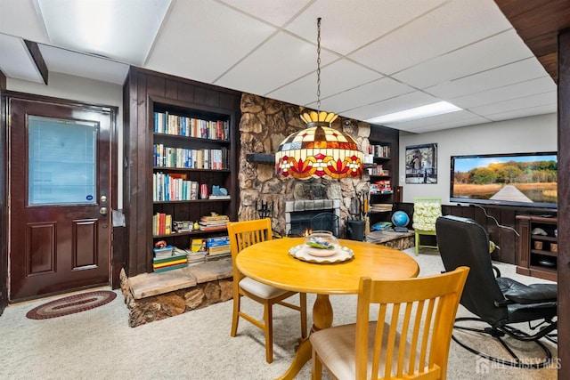 41 1st St, Franklin Twsp, NJ 08873 - carpeted dining area with built in shelves, a stone fireplace, and a paneled ceiling