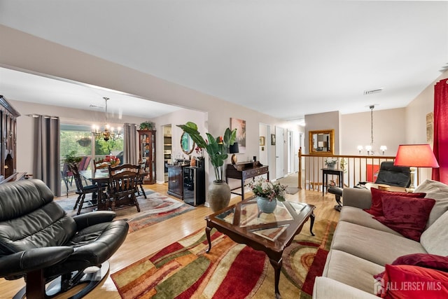 41 1st St, Franklin Twsp, NJ 08873 - living area with a chandelier and light wood-style flooring