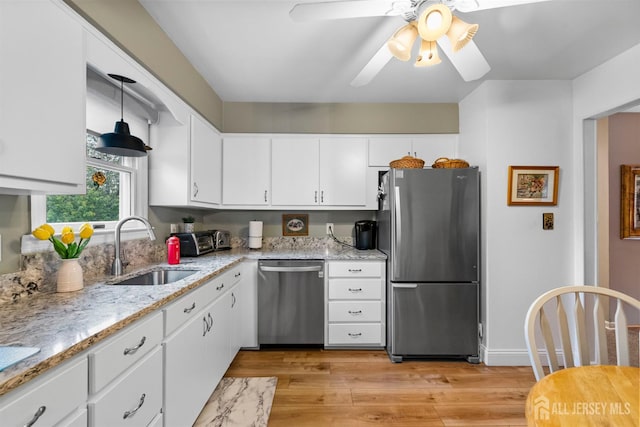 41 1st St, Franklin Twsp, NJ 08873 - kitchen featuring stainless steel appliances, a sink, white cabinetry, light wood-style floors, and ceiling fan