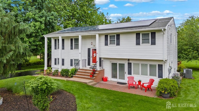 41 1st St, Franklin Twsp, NJ 08873 - split foyer home with roof mounted solar panels, a front yard, cooling unit, and a patio area