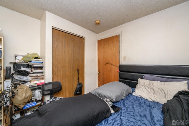 bedroom with a closet and a textured ceiling