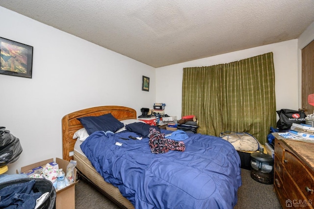 carpeted bedroom featuring a textured ceiling