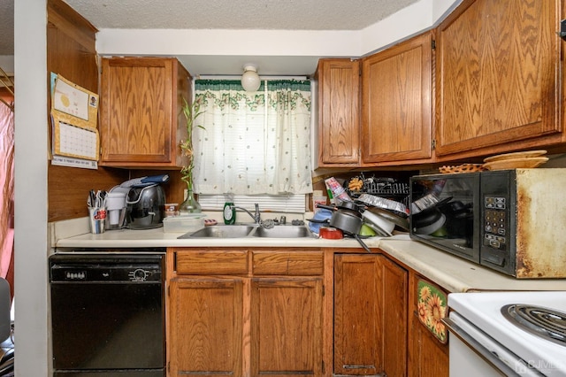 kitchen with a sink, black appliances, brown cabinetry, and light countertops