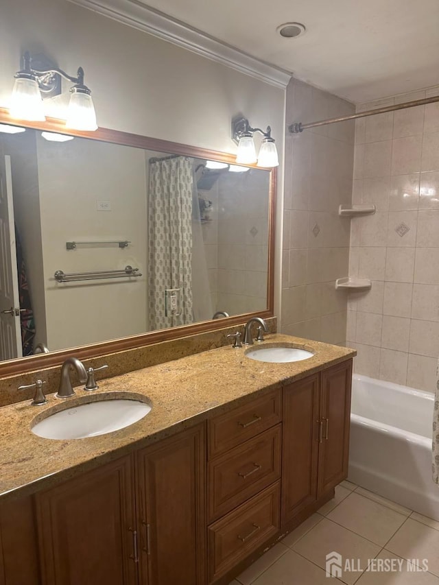 bathroom featuring tile patterned flooring, ornamental molding, double vanity, and shower / bath combo with shower curtain