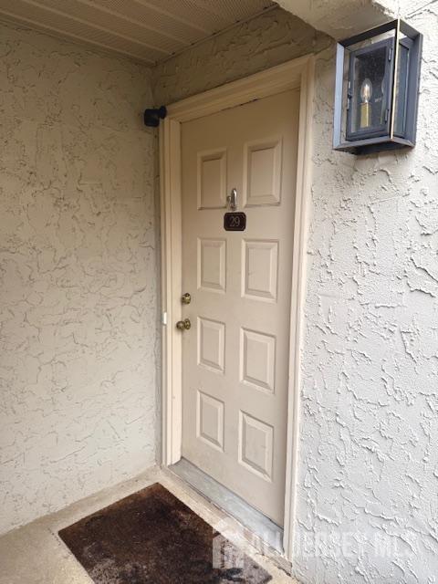 property entrance featuring stucco siding