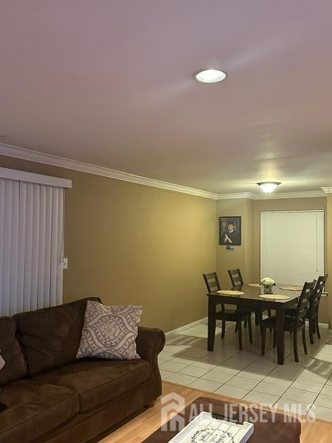 living room featuring ornamental molding and light tile patterned flooring