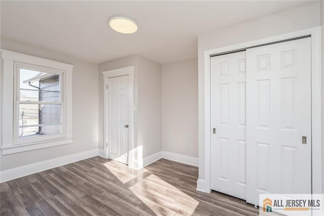 unfurnished bedroom featuring dark hardwood / wood-style floors