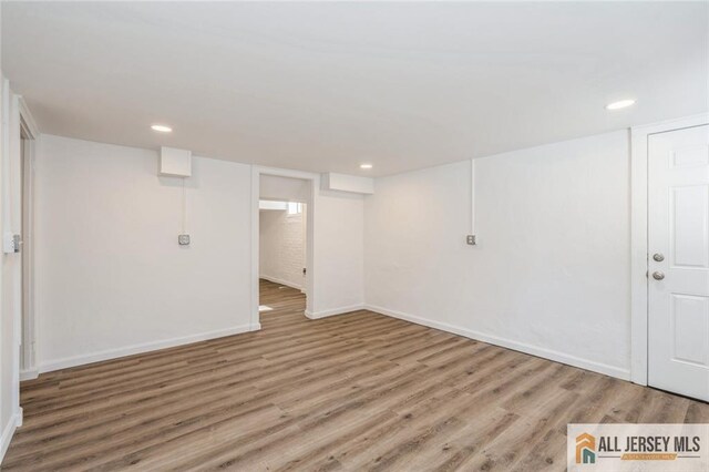 basement with hardwood / wood-style flooring