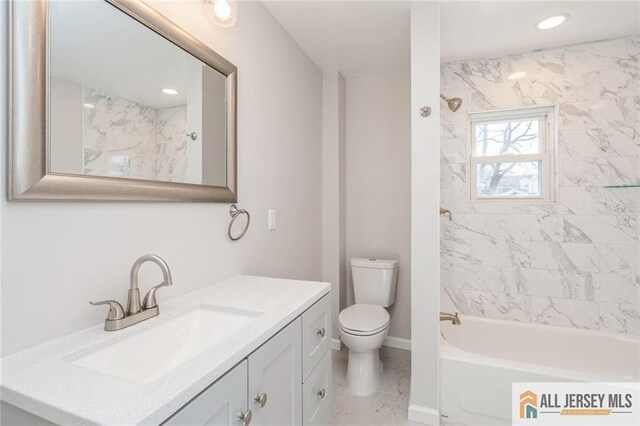 full bathroom with toilet, tiled shower / bath combo, and vanity