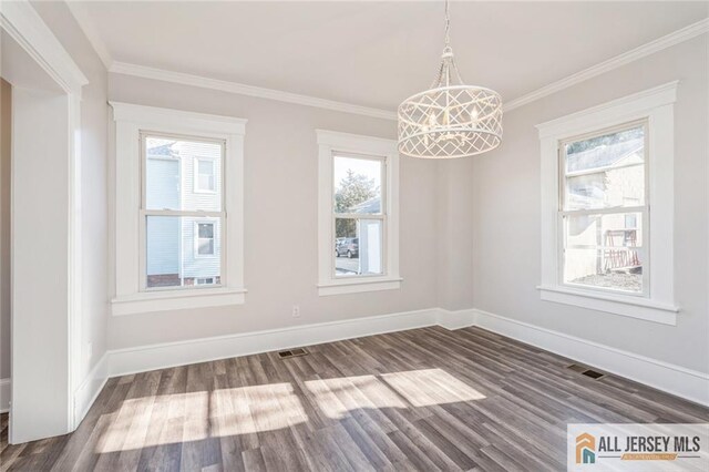 unfurnished dining area with hardwood / wood-style flooring, ornamental molding, and plenty of natural light