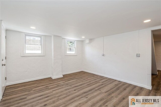 basement featuring dark hardwood / wood-style flooring