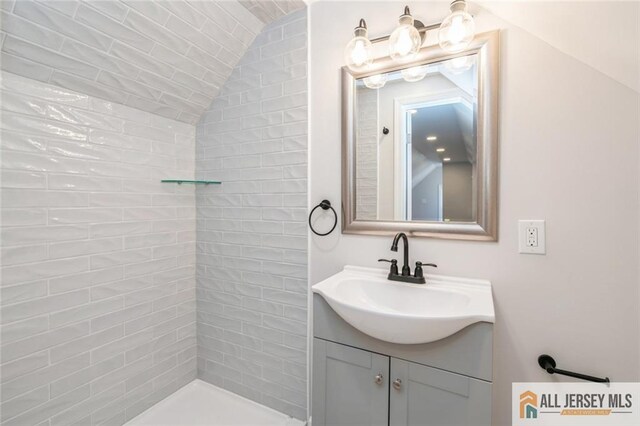 bathroom featuring lofted ceiling and vanity