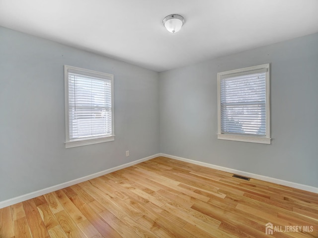 unfurnished room with light hardwood / wood-style floors