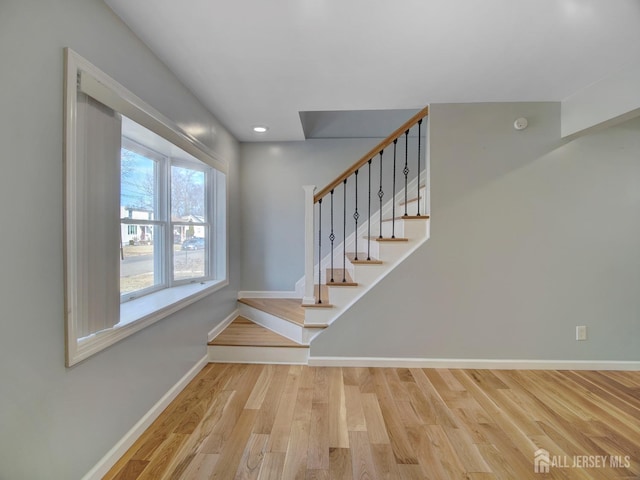 stairway featuring wood-type flooring