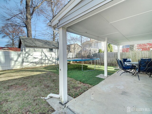 view of yard featuring a trampoline and a patio area