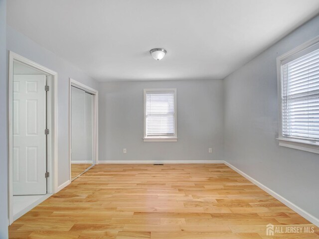 empty room with light hardwood / wood-style flooring