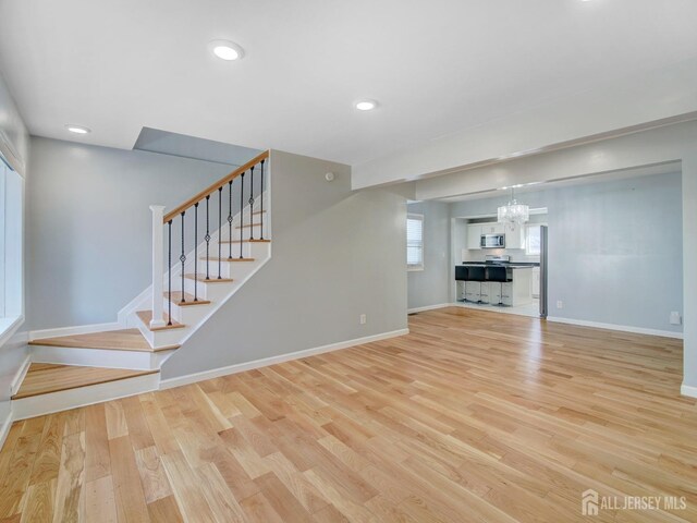 unfurnished living room with light wood-type flooring