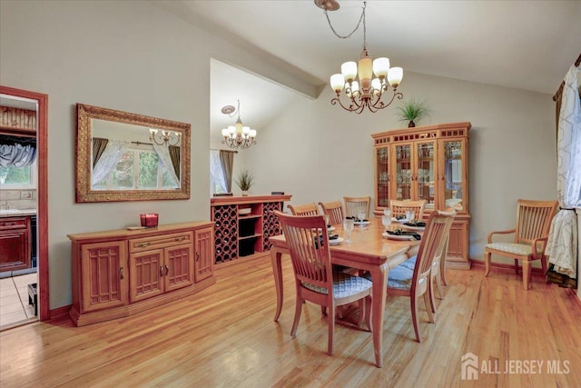 12 Euclid Rd, South Amboy, NJ 08879 - dining area with a chandelier, lofted ceiling, and light wood-type flooring