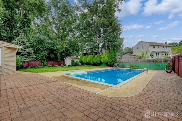 12 Euclid Rd, South Amboy, NJ 08879 - view of pool featuring a storage shed, a patio, a fenced backyard, and a diving board