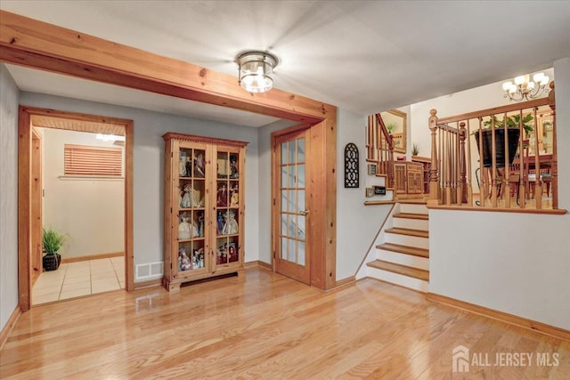 12 Euclid Rd, South Amboy, NJ 08879 - empty room featuring a chandelier, wood finished floors, and stairway