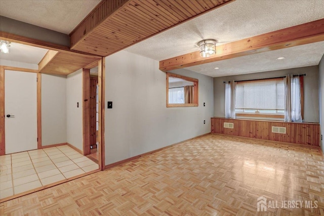 12 Euclid Rd, South Amboy, NJ 08879 - spare room with a textured ceiling and beamed ceiling