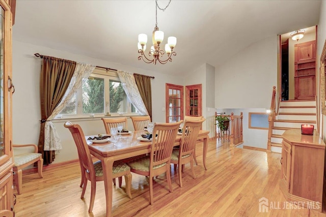 12 Euclid Rd, South Amboy, NJ 08879 - dining area featuring lofted ceiling, light wood finished floors, a chandelier, and stairway