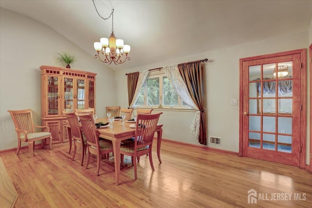 12 Euclid Rd, South Amboy, NJ 08879 - dining room featuring a chandelier, lofted ceiling, and light wood-style floors