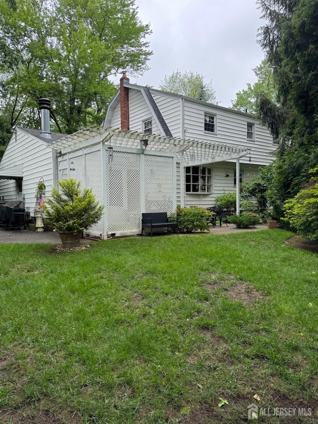 13 Concord St, Edison, NJ 08820 - back of house with a pergola, a yard, a chimney, and a patio