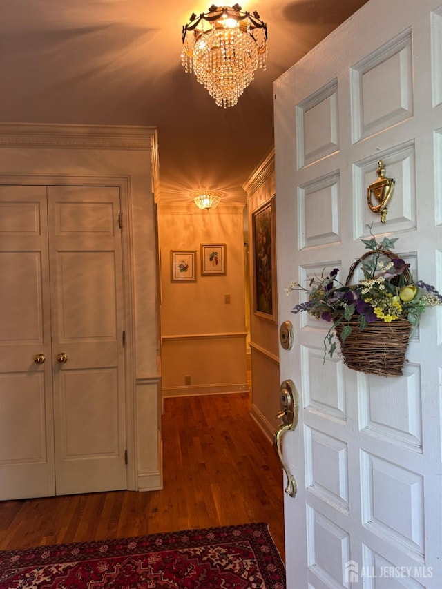 13 Concord St, Edison, NJ 08820 - foyer featuring a chandelier, ornamental molding, and dark wood-style floors