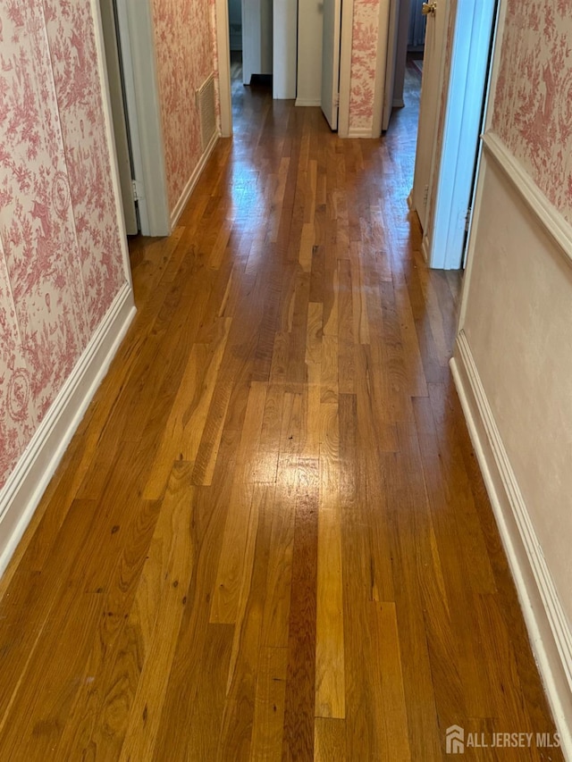 13 Concord St, Edison, NJ 08820 - corridor with wallpapered walls and dark wood finished floors
