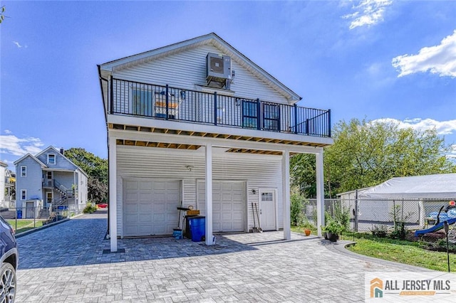 back of house featuring a garage and central air condition unit