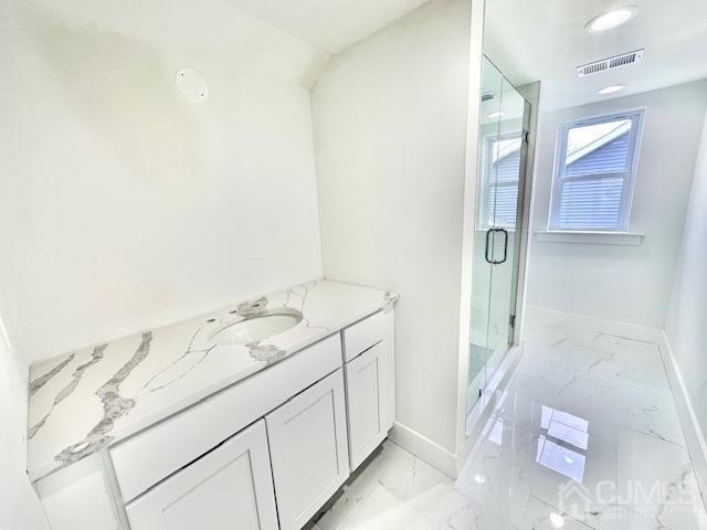 9 Melrose Ave, Sayreville, NJ 08879 - bathroom with a shower stall, marble finish floor, baseboards, and visible vents