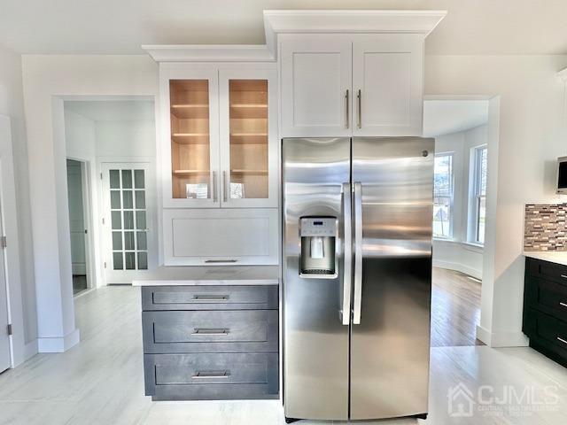 9 Melrose Ave, Sayreville, NJ 08879 - kitchen featuring light countertops, light wood-type flooring, stainless steel refrigerator with ice dispenser, and glass insert cabinets