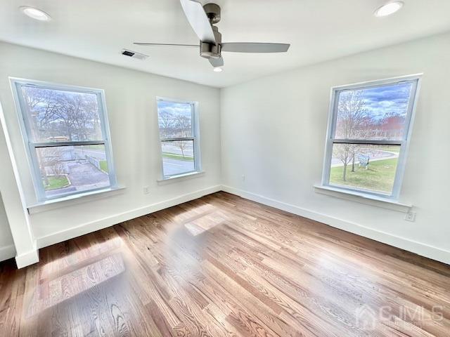 9 Melrose Ave, Sayreville, NJ 08879 - unfurnished room featuring wood finished floors, baseboards, a ceiling fan, and visible vents