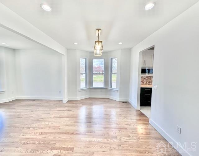 9 Melrose Ave, Sayreville, NJ 08879 - unfurnished living room featuring recessed lighting, light wood-style floors, and baseboards
