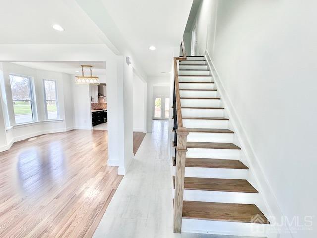 9 Melrose Ave, Sayreville, NJ 08879 - stairs featuring baseboards, wood finished floors, and recessed lighting