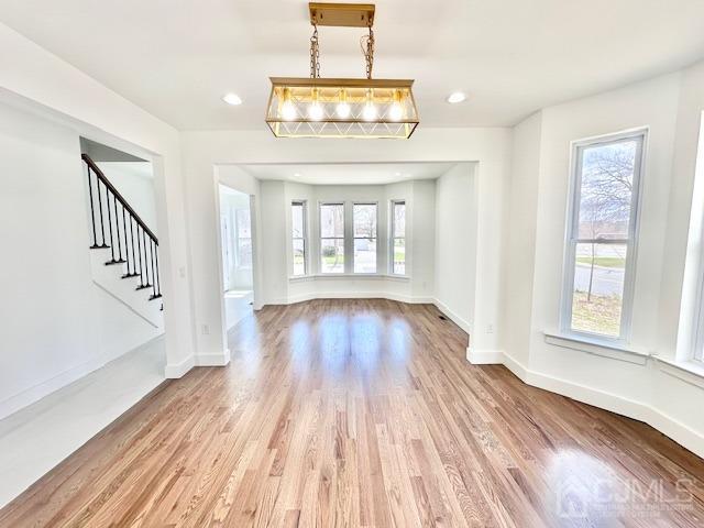 9 Melrose Ave, Sayreville, NJ 08879 - unfurnished living room with plenty of natural light, wood finished floors, baseboards, and stairway