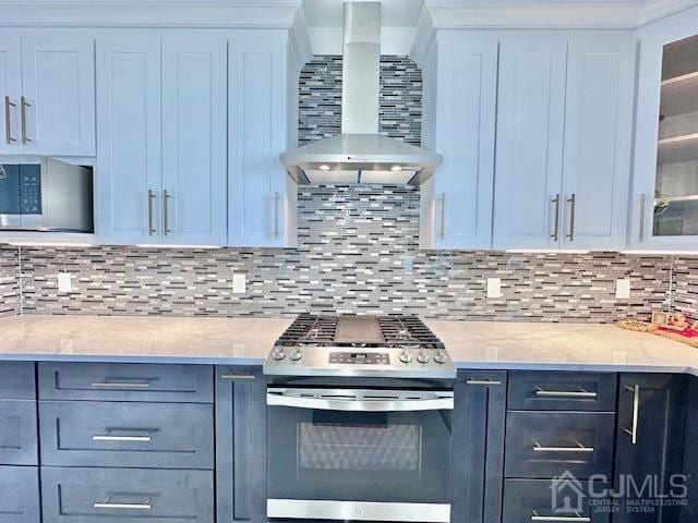 9 Melrose Ave, Sayreville, NJ 08879 - kitchen featuring wall chimney exhaust hood, stainless steel appliances, glass insert cabinets, and tasteful backsplash