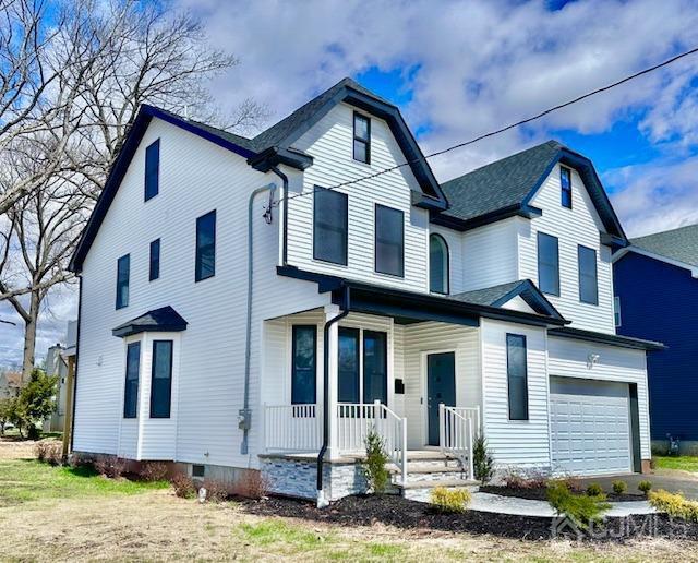 9 Melrose Ave, Sayreville, NJ 08879 - view of front facade featuring a porch, aphalt driveway, and a garage
