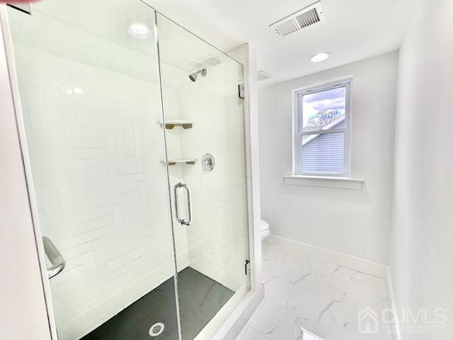 9 Melrose Ave, Sayreville, NJ 08879 - full bathroom featuring a shower stall, toilet, marble finish floor, baseboards, and visible vents