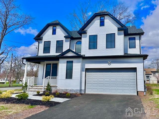 9 Melrose Ave, Sayreville, NJ 08879 - traditional home with an attached garage, driveway, and covered porch