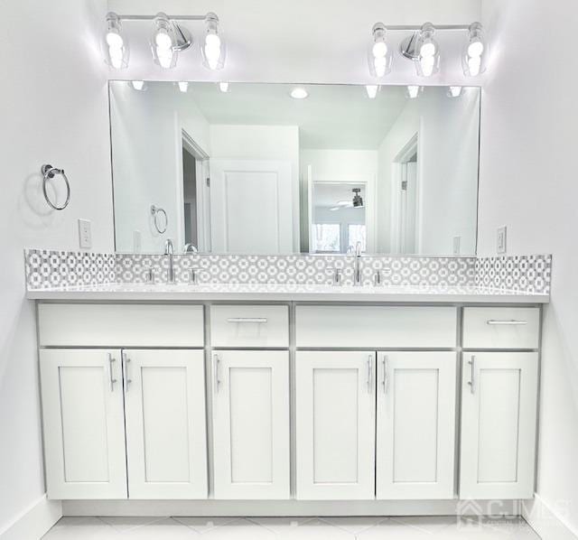 9 Melrose Ave, Sayreville, NJ 08879 - bathroom featuring double vanity, baseboards, and a sink